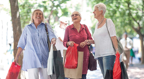 Senior and mature women strolling with shopping bags in city Senior and mature women strolling with shopping bags in city