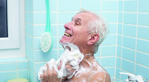 Senior,Man,Washing,His,Body,With,Soap,In,Bath.