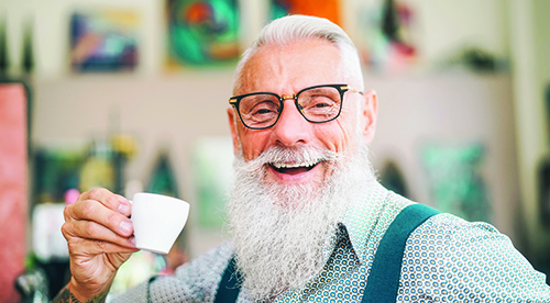 Happy senior drinking coffee in bar - Hipster older male having coffee break - Lifestyle people concept