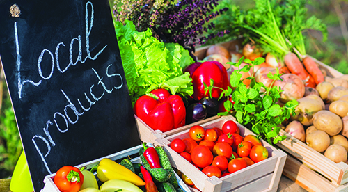 Counter,With,Fresh,Vegetables,And,A,Sign,Of,Local,Products
